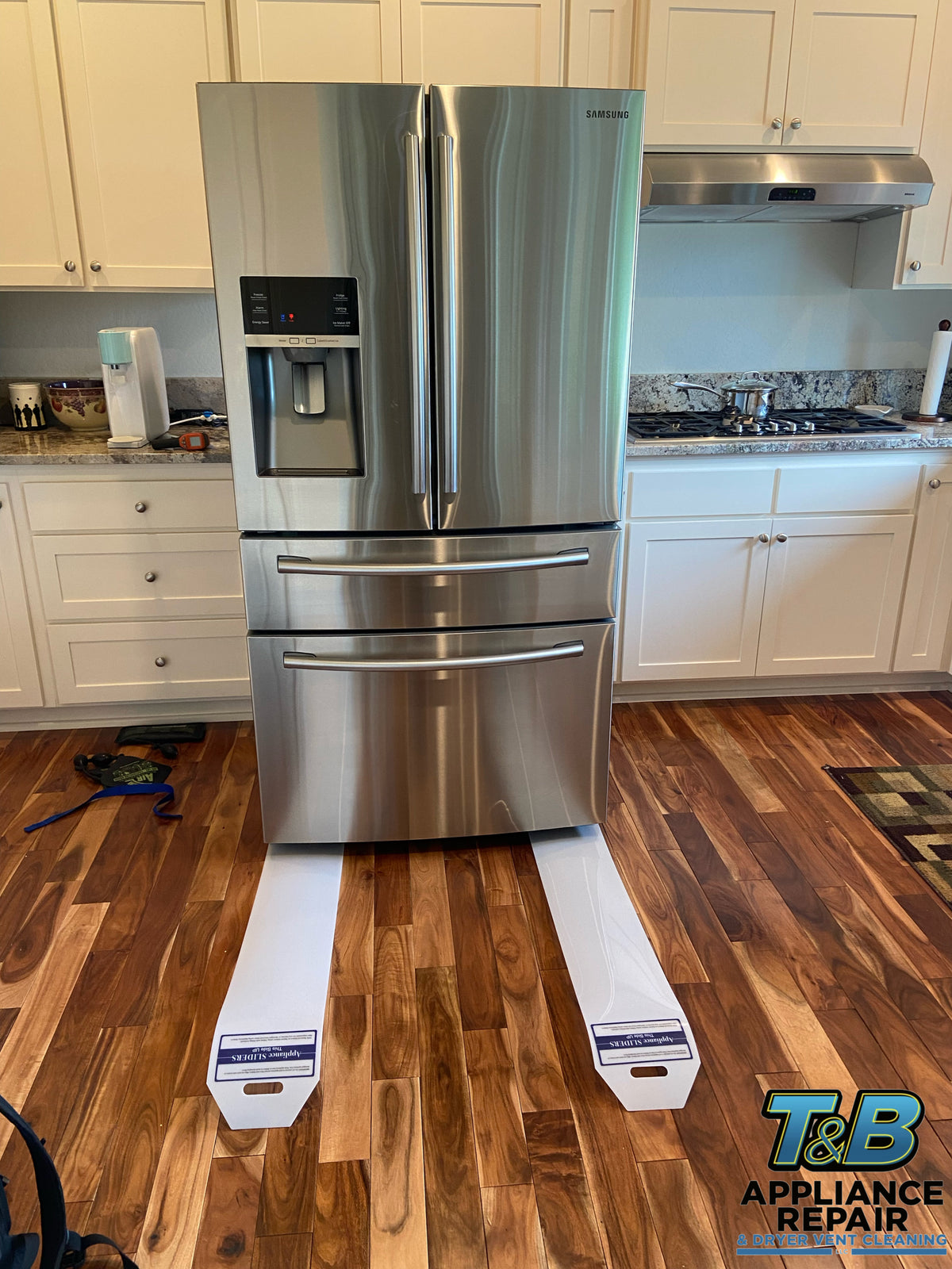T&B technician diagnosing a refrigerator in Southern Oregon